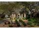 Charming brick home featuring a bay window and landscaped front yard at dusk at 956 Provincial Cir, Mount Pleasant, SC 29464