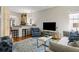 Open-concept living room with hardwood floors, comfortable seating, and access to the kitchen at 956 Provincial Cir, Mount Pleasant, SC 29464