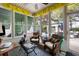 Cozy sunroom featuring wicker chairs, bright windows, and views of the outdoor living space at 956 Provincial Cir, Mount Pleasant, SC 29464