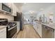 Bright kitchen with stainless steel appliances, granite countertops, and wood-look flooring at Tbd O'Leary Circle, Summerville, SC 29483