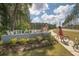 Community entrance with oversized 'Welcome' sign, landscaping, and residents enjoying a bike ride at 1014 Marsh Harrier Dr # Cc3-1-5, Ravenel, SC 29470