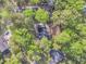 Aerial view displays the house surrounded by mature trees, highlighting its secluded location at 109 Dan Miler Ln, Summerville, SC 29483
