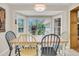 The dining area features a bay window offering a view of the backyard and a wooden table at 109 Dan Miler Ln, Summerville, SC 29483