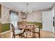 Inviting dining room featuring floral wallpaper, a chandelier, and a round table with comfortable seating at 109 Dan Miler Ln, Summerville, SC 29483