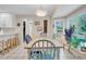 A sunlit dining room features a wooden table with colorful chairs and a large picture window at 109 Dan Miler Ln, Summerville, SC 29483