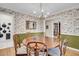 Formal dining room featuring a round table, hardwood floors, floral wallpaper, and a decorative chandelier at 109 Dan Miler Ln, Summerville, SC 29483