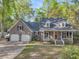 Charming brick home with a welcoming front porch and well-manicured lawn, plus a two-car garage at 109 Dan Miler Ln, Summerville, SC 29483