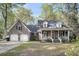 Inviting home boasts a brick facade, covered porch, dormer windows, and attached two-car garage at 109 Dan Miler Ln, Summerville, SC 29483