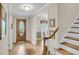 Bright foyer with wood flooring, staircase, and access to dining area, creating a welcoming entry at 109 Dan Miler Ln, Summerville, SC 29483