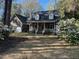 Charming brick home featuring a cozy front porch and a well-manicured lawn with lovely floral accents at 109 Dan Miler Ln, Summerville, SC 29483