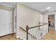 Upstairs hallway with hardwood floors and wooden railing leading to bedrooms at 109 Dan Miler Ln, Summerville, SC 29483