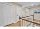 Upstairs hallway with hardwood floors and wooden railing leading to bedrooms and closets at 109 Dan Miler Ln, Summerville, SC 29483