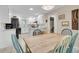 The kitchen and dining area feature white cabinetry and a wooden table with colorful chairs at 109 Dan Miler Ln, Summerville, SC 29483