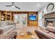 Spacious living room with hardwood floors, built-in shelves, fireplace, and an open layout to the kitchen at 109 Dan Miler Ln, Summerville, SC 29483