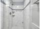 Modern bathroom shower featuring white marble tiling, glass enclosure, and upgraded shower head at 109 Dan Miler Ln, Summerville, SC 29483