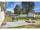 This spacious backyard features a dog kennel, a fire pit, a built-in grill, and mature trees for outdoor enjoyment at 1113 Smithfield Pl, Hanahan, SC 29410