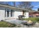 A backyard featuring a fire pit, a built-in grill, French doors and brown shutters on a brick home at 1113 Smithfield Pl, Hanahan, SC 29410