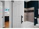 Bathroom with blue walls, gray tiled shower and vanity area featuring a marble countertop and dark gray cabinets at 1113 Smithfield Pl, Hanahan, SC 29410