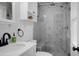 Modern bathroom featuring marble tiles, a glass-enclosed shower, white fixtures, and gray mosaic tile flooring at 1113 Smithfield Pl, Hanahan, SC 29410