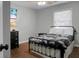 Bedroom featuring wood floors, a ceiling fan, blinds, a flat-screen TV, and a black-painted dresser at 1113 Smithfield Pl, Hanahan, SC 29410