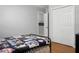 Bedroom featuring light wood floors, white closet doors, blinds, and a black-painted bed frame at 1113 Smithfield Pl, Hanahan, SC 29410