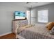 Bedroom features wood floors, a ceiling fan, blinds, a flat-screen TV, and a white-painted dresser at 1113 Smithfield Pl, Hanahan, SC 29410