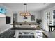 Contemporary dining area with large table, stylish pendant light, and backyard views at 1113 Smithfield Pl, Hanahan, SC 29410