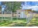 Outdoor dog kennel featuring a chain-link fence, small dog door and a covered area with a yellow hose hanging outside at 1113 Smithfield Pl, Hanahan, SC 29410
