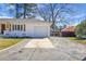 Painted-brick home featuring a long driveway leading to a garage at 1113 Smithfield Pl, Hanahan, SC 29410