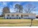 Charming painted-brick home featuring a lush lawn and tasteful wood shutters on a sunny day at 1113 Smithfield Pl, Hanahan, SC 29410