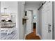 Hallway leading to dining area featuring white sliding barn door and wood accents at 1113 Smithfield Pl, Hanahan, SC 29410