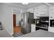 Well-lit kitchen showcasing stainless steel fridge, black range, and white cabinets at 1113 Smithfield Pl, Hanahan, SC 29410
