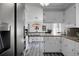 Spacious kitchen with view into dining area with custom table and pendant lighting at 1113 Smithfield Pl, Hanahan, SC 29410