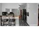 Open concept kitchen with dark flooring, sleek black appliances, and breakfast bar seating at 1113 Smithfield Pl, Hanahan, SC 29410