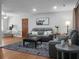 Inviting living room with stylish gray furnishings and unique cow art piece at 1113 Smithfield Pl, Hanahan, SC 29410