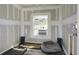 This unfinished room features an air conditioner, dog beds, and drywall on the walls, ready for your personal touch at 1113 Smithfield Pl, Hanahan, SC 29410