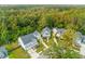 Aerial view captures the neighborhood layout with manicured lawns, and mature trees at 1213 Captain Rivers Dr, Charleston, SC 29412