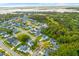 Aerial view of a neighborhood showcasing beautiful homes, lush greenery, and tranquil waterways at 1213 Captain Rivers Dr, Charleston, SC 29412