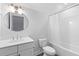 Bright bathroom featuring a vanity with round mirror, toilet and shower with white curtain at 1213 Captain Rivers Dr, Charleston, SC 29412
