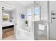 This bright bathroom has a bathtub, shower with glass wall, and natural light coming through two windows at 1213 Captain Rivers Dr, Charleston, SC 29412