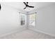Bright bedroom with two windows, neutral carpet, and modern ceiling fan at 1213 Captain Rivers Dr, Charleston, SC 29412