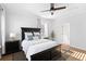 This bedroom includes a bed, a ceiling fan, hardwood floors, and natural light streaming through the windows at 1213 Captain Rivers Dr, Charleston, SC 29412