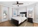 The bright bedroom features a ceiling fan, a bed, a rug, and natural light coming from two windows at 1213 Captain Rivers Dr, Charleston, SC 29412