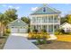 Charming two-story home with a front porch, a detached garage, and beautiful landscaping at 1213 Captain Rivers Dr, Charleston, SC 29412