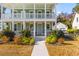 Charming two-story home with a walkway leading to the front door and well-manicured landscaping at 1213 Captain Rivers Dr, Charleston, SC 29412