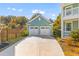 Detached garage with a double door and a large concrete driveway at 1213 Captain Rivers Dr, Charleston, SC 29412