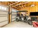 Garage featuring golf cart, exposed wood beams, and storage at 1213 Captain Rivers Dr, Charleston, SC 29412