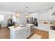 Modern kitchen with white cabinetry, stainless steel appliances, quartz countertops, and island with sink at 1213 Captain Rivers Dr, Charleston, SC 29412