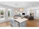 Open concept kitchen featuring an island with seating, modern appliances, and access to outdoor spaces at 1213 Captain Rivers Dr, Charleston, SC 29412