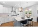 Modern kitchen with white cabinets, stainless steel appliances, pendant lighting, and an island with seating at 1213 Captain Rivers Dr, Charleston, SC 29412